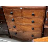 A Victorian mahogany bow front chest of 3 long and 2 short drawers, with shaped apron, on bracket