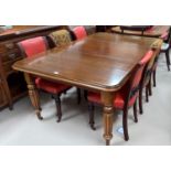 A Victorian mahogany wind-out dining table, on tapering reeded legs and castors, 1 spare leaf,