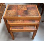 A nest of teak tables with tile tops; a tall stool