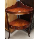 A reproduction mahogany corner cupboard with open front