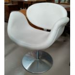 A vintage Artifort swivel chair with white leather effect seat