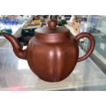 A Chinese Yixing terracotta stone ware teapot of ribbed spherical form impressed square seal mark to