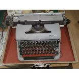 A 1950's Olympia portable typewriter in original box