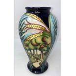 A modern Moorcroft vase of inverted baluster form, decorated with ears of wheat and reserve panels