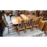 An Ercol Windsor style dining suite comprising extending table and 8 chairs