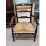 An oak framed rush seat armchair