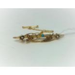 A gold brooch set with seed pearls and small turquoise, marks unclear but tests as 18 carat, 3.2gm