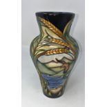 A modern Moorcroft vase of tapering form, decorated with ears of wheat and reserve panels of birds