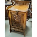 An Edwardian fall front coal box in carved pollard oak