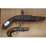 A reproduction distressed flintlock pistol; a similar muff pistol