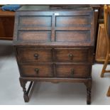 A 1930's beaded oak bureau with fall front and 2 drawers
