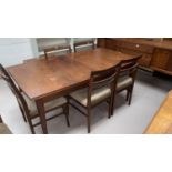 A 1960's walnut and sapele dining suite comprising table with extending rectangular top, 5