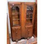 A golden oak side cabinet with double glazed doors over 2 drawers and double cupboard, on bulbous