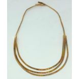 A sectional necklace in 3 coloured gold, stamped '750', weight 27 g