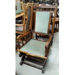 An early 20th century American rocking chair in green dralon