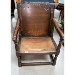 A monks chair in carved oak with hinged top and pierced back, on turned supports (requires