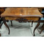 A Victorian serpentine front burr walnut fold over baize lined card table with carved frieze and