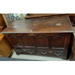 An 18th century country made oak mule chest with hinged top, 4 arched fielded panels to the front