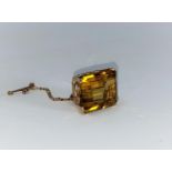 A yellow metal brooch set large cushion cut rectangular topaz, scrollwork frame, unmarked, 11 gm