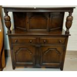A reproduction oak court cupboard with single cupboard over 2 drawers and 2 cupboards