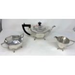An Art Deco octagonal silver plated 3 piece tea set on raised feet with entwined Celtic border