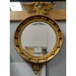A late 19th century bevelled edge wall mirror in gilt halo frame with eagle finial