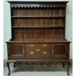 A Georgian style 19th century oak Welsh dresser with moulded cornice and scalloped frieze and 2