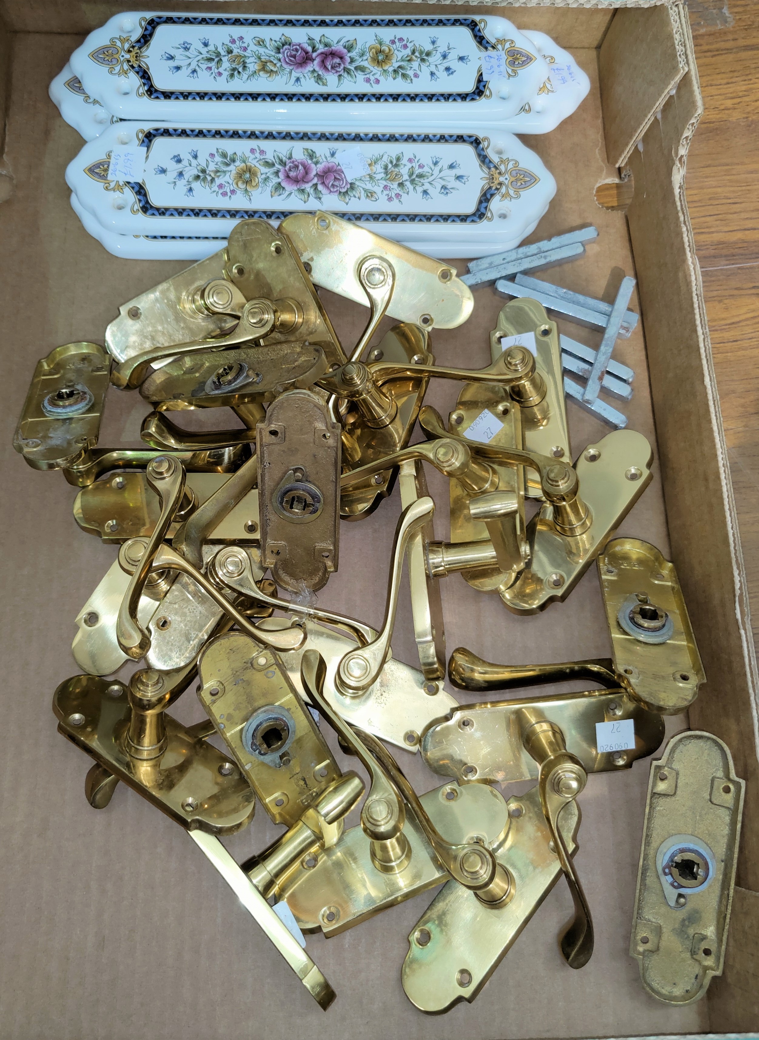 A selection of brass door handles; 5 ceramic finger plates