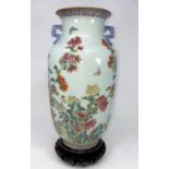 A Chinese vase decorated with detailed flowers and insects, flared rim and 2 handles with