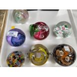 Six limited edition paperweights by Caithness, signed; a millefiori paperweight