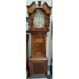 A large mid 19th Century figured mahogany long case clock with swan neck pediment and turned pillars