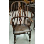 A 19th century fiddle back winsor arm chair with turned legs