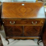 An Edwardian inlaid mahogany bureau with fall front, drawer, and double cupboard