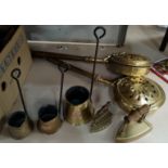 Three graduating vintage brass cider measures, vintage brass irons and two brass bed pans