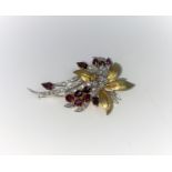 An 18 carat hallmarked gold floral spray brooch set 50 graduating diamonds, approx, and 11 rubies,