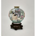 A Chinese porcelain snuff bottle on stand, nude figures smoking to one side, characters to the