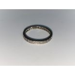 A white metal diamond set eternity ring, unmarked, tests as 18 ct, 2 gm