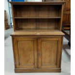 A late 19th century oak chiffonier with double cupboard and open shelf over