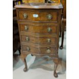 A Singer treadle sewing machine; a 1950's walnut record cabinet; a mahogany reproduction dwarf 4