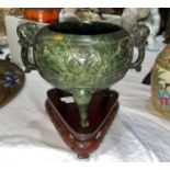 A cauldron censor in spinach jade coloured soapstone, with elephant mask handles and relief