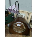 A 1930's striking mantel clock in oak case; a Tiffany style table lamp; a collection of OS maps