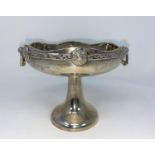 A hallmarked silver shallow 2 handles dish with relief Celtic hand on inverted trumpet column by