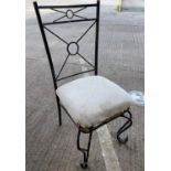 A wrought metal conservatory garden suite comprising of 4 chairs and occasional table