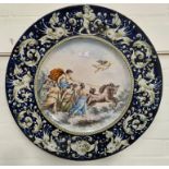 A large circular 19th century wall plaque depicting a man riding a chariot surrounded by women,
