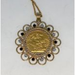 A 1905 sovereign in 9 carat hallmarked gold jewelled clip pendant set diamonds and sapphires, 13 gm,