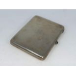 A Russian white metal cigarette case stamped 875 with a head mark to interior, a red cabochon