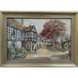 Squire Howard, figure in the door of a half timbered house, watercolour, signed, 39 x 45 cm framed