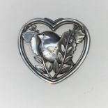 A Georg Jensen Danish silver heart shaped brooch with bird sitting on fronds with outstretched