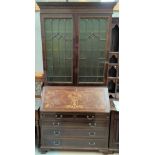 An Edwardian mahogany bureau/bookcase with extensive ebony and boxwood line inlay, the upper section