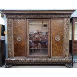 A late 19th century Continental monumental side/display cabinet with extensive carved decoration,